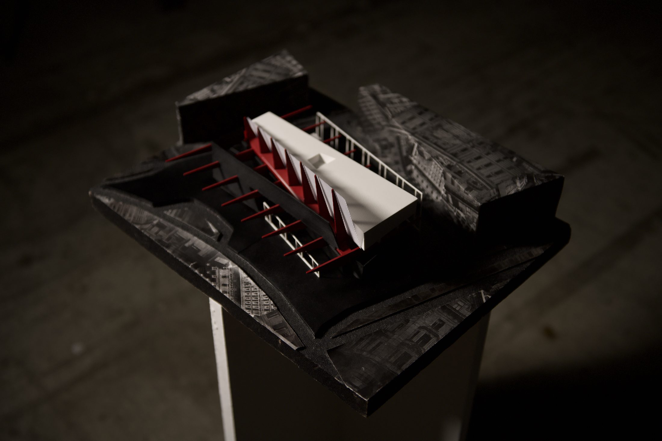 Site model open showing red structural elements and auditorium volumes