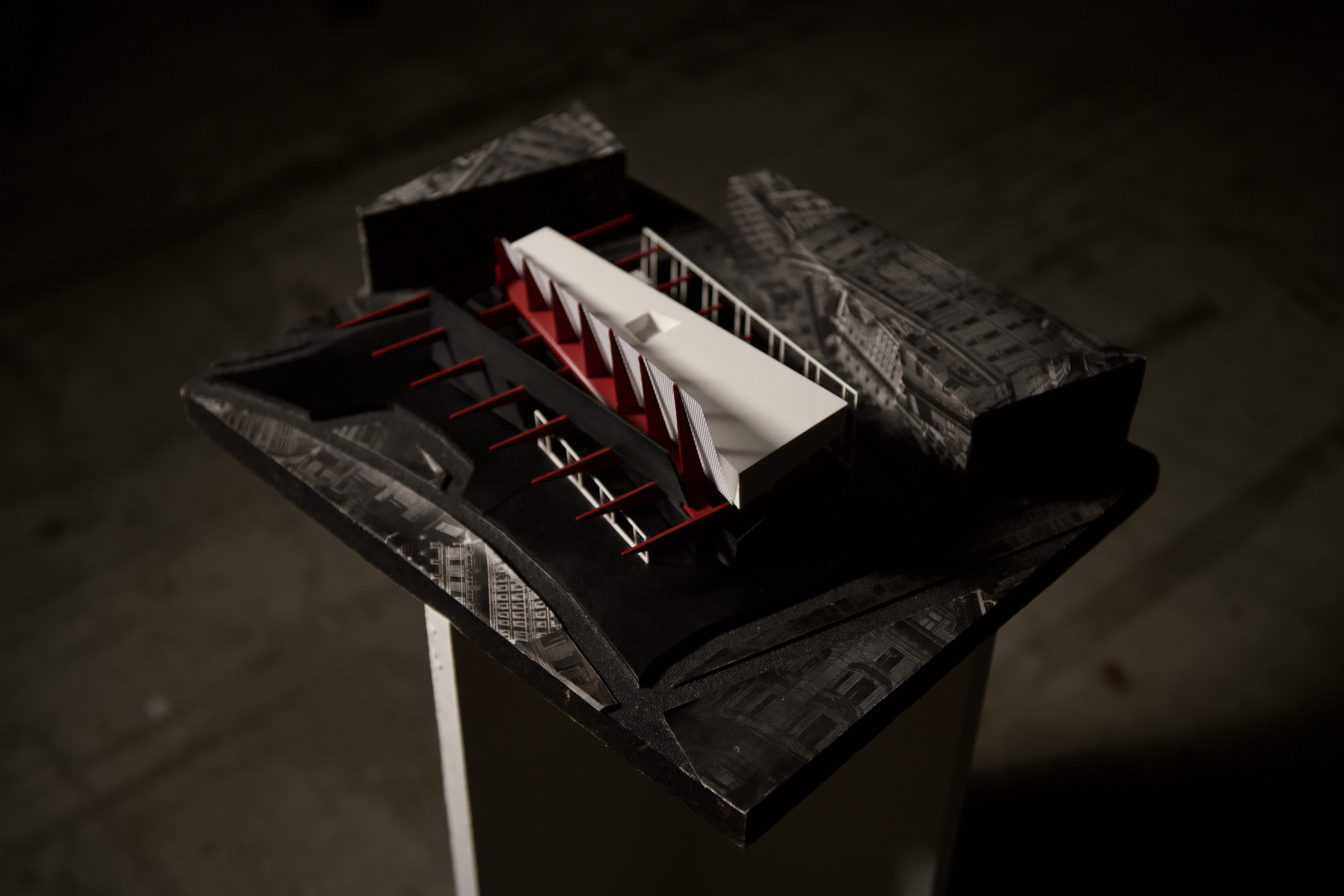 Site model open showing red structural elements and auditorium volumes