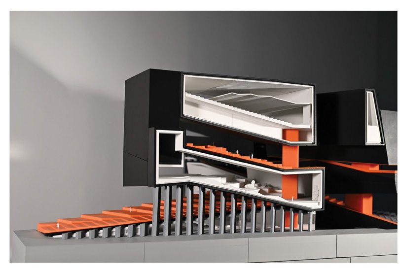 Sectional model — black volumes slid open to expose the orange seam