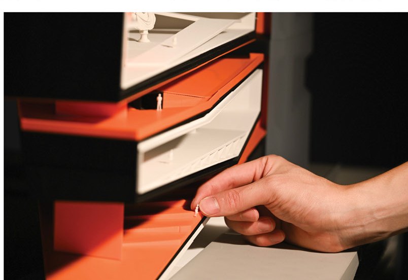 Sectional model — hand opening an orange program drawer