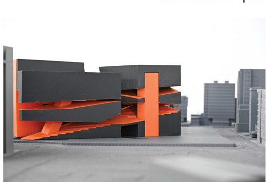 Massing model in site context — orange seams between black shards