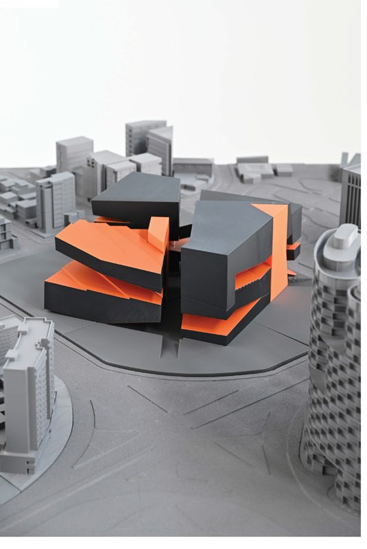 Massing model in site context — aerial view of the carved block